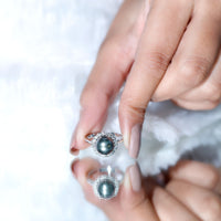 Natural Tahitian pearl and diamond halo engagement ring from Rosec Jewels, showcasing a lustrous black pearl surrounded by sparkling diamonds.