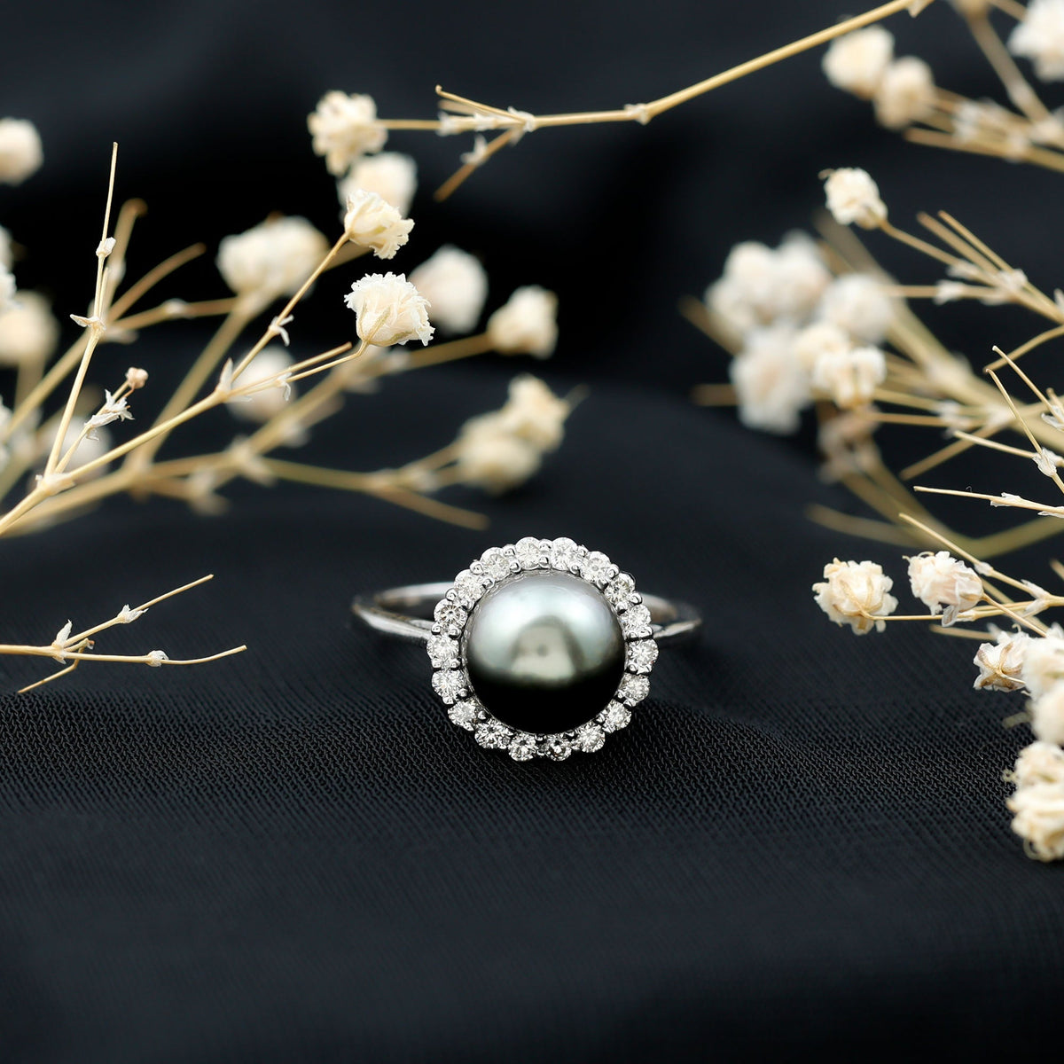 Natural Tahitian pearl and diamond halo engagement ring from Rosec Jewels, featuring a central pearl surrounded by sparkling diamonds.