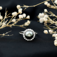Natural Tahitian pearl and diamond halo engagement ring from Rosec Jewels, featuring a central pearl surrounded by sparkling diamonds.