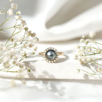 Natural Tahitian pearl and diamond halo engagement ring by Rosec Jewels featuring a central pearl surrounded by sparkling diamonds.