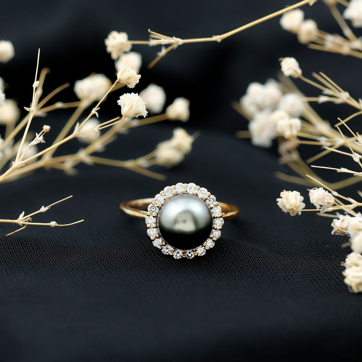 Natural Tahitian pearl and diamond halo engagement ring from Rosec Jewels, featuring a central pearl surrounded by sparkling diamonds.