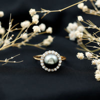 Natural Tahitian pearl and diamond halo engagement ring from Rosec Jewels, featuring a central pearl surrounded by sparkling diamonds.