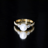 Cultured 7.4 carat freshwater pearl engagement ring with moissanite from Rosec Jewels featuring a yellow gold band.
