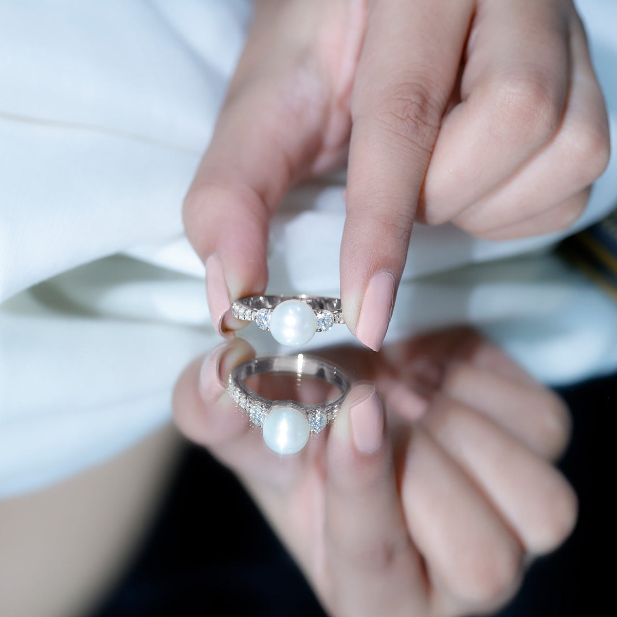 Cultured 7.4 carat freshwater pearl engagement ring with moissanite, featuring a delicate band and intricate design by Rosec Jewels.
