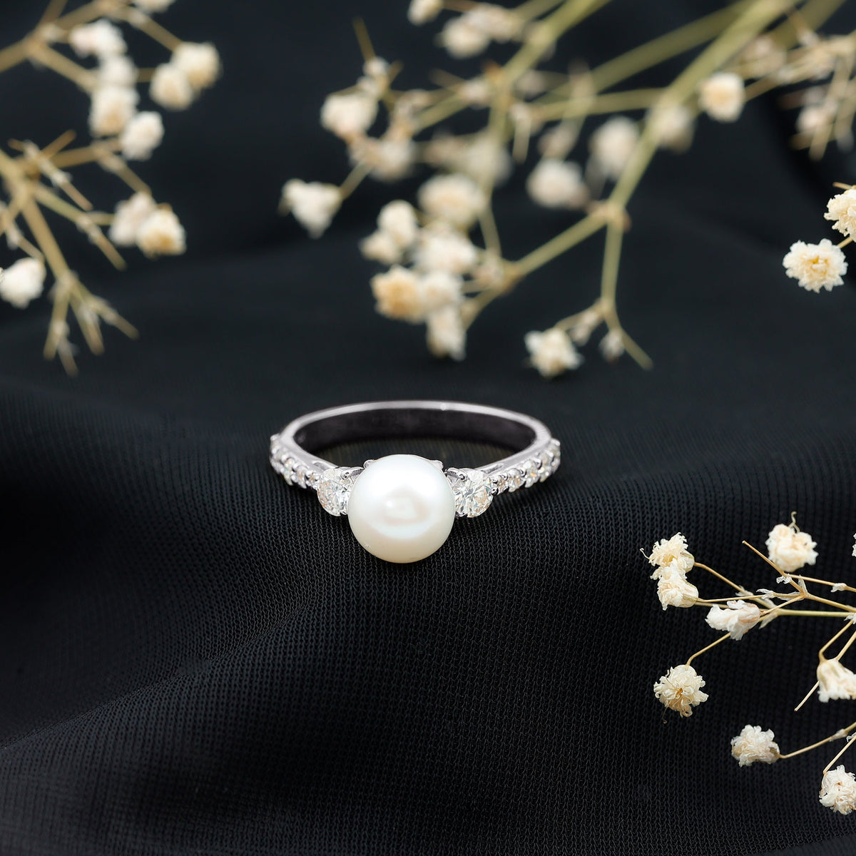 Cultured 7.4 Carat freshwater pearl engagement ring with moissanite accents, featuring a delicate gold band from Rosec Jewels.