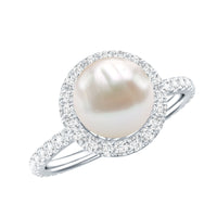 Cultured 7.4 carat freshwater pearl diamond engagement ring with halo setting, featuring intricate metalwork and sparkling stones.