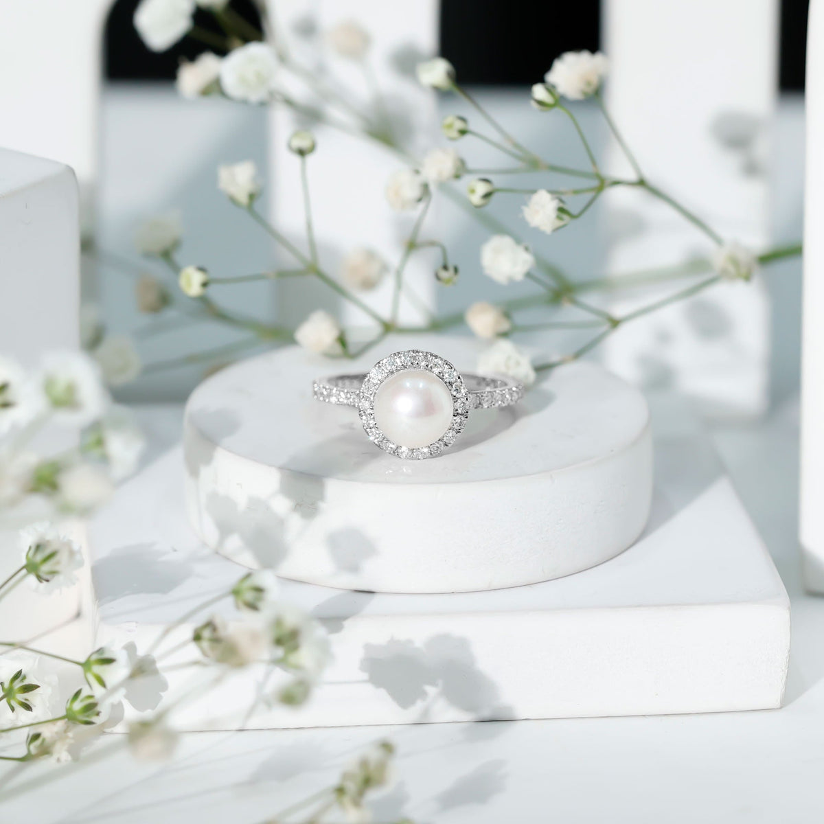 Rosec Jewels cultured 7.4 carat freshwater pearl diamond engagement ring with halo, featuring a central pearl surrounded by sparkling diamonds.