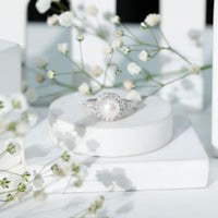 Rosec Jewels cultured 7.4 carat freshwater pearl diamond engagement ring with halo, featuring a central pearl surrounded by sparkling diamonds.