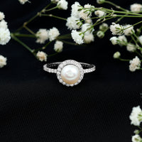 Rosec Jewels cultured 7.4 carat freshwater pearl diamond engagement ring with halo, featuring a central pearl surrounded by sparkling diamonds.