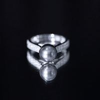 Natural Tahitian Pearl cathedral engagement ring with diamond side stones, featuring a yellow gold band by Rosec Jewels.