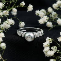 Natural Tahitian pearl cathedral engagement ring with diamond side stones by Rosec Jewels, featuring a lustrous black pearl centerpiece.