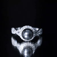 Yellow gold crossover engagement ring with real Tahitian pearl and diamond accents from Rosec Jewels.