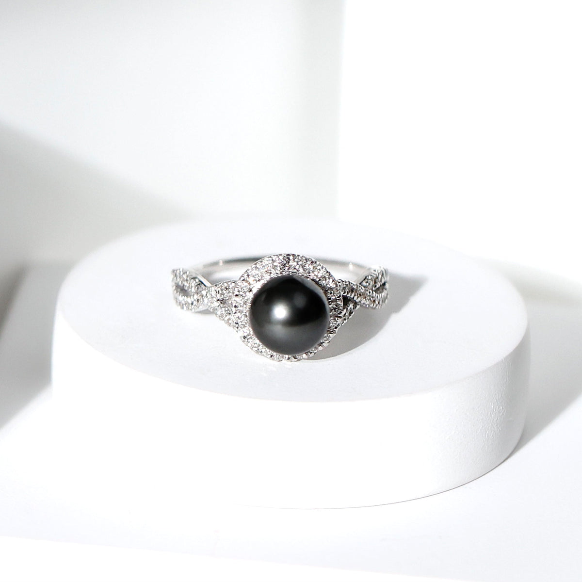 Real Tahitian pearl and diamond crossover engagement ring by Rosec Jewels, showcasing elegant pearl and sparkling diamonds in a sleek design.