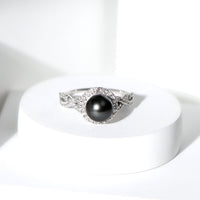 Real Tahitian pearl and diamond crossover engagement ring by Rosec Jewels, showcasing elegant pearl and sparkling diamonds in a sleek design.