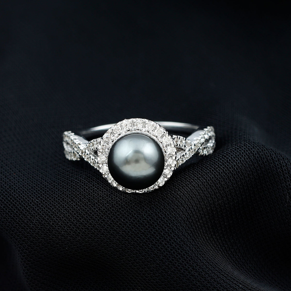 Real Tahitian pearl and diamond crossover engagement ring by Rosec Jewels, featuring a pearl and sparkling diamonds on a gold band.