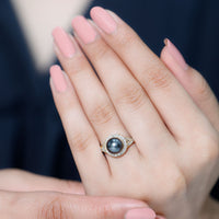 Real Tahitian pearl and diamond crossover engagement ring by Rosec Jewels, showcasing a lustrous pearl and sparkling diamonds in a elegant design.