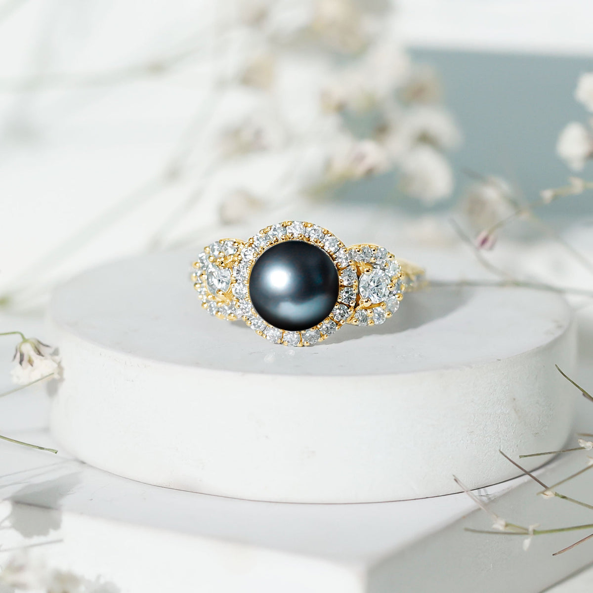7.5 carat round black pearl engagement ring with moissanite accents by Rosec Jewels, featuring a sleek gold band and elegant design.
