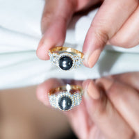 7.5 carat round black pearl engagement ring with moissanite accents by Rosec Jewels, featuring a sleek silver band and elegant design.