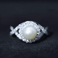 Rosec Jewels 7.4 carat freshwater pearl engagement ring with moissanite crossover shank, featuring a white gemstone on a elegant ring.