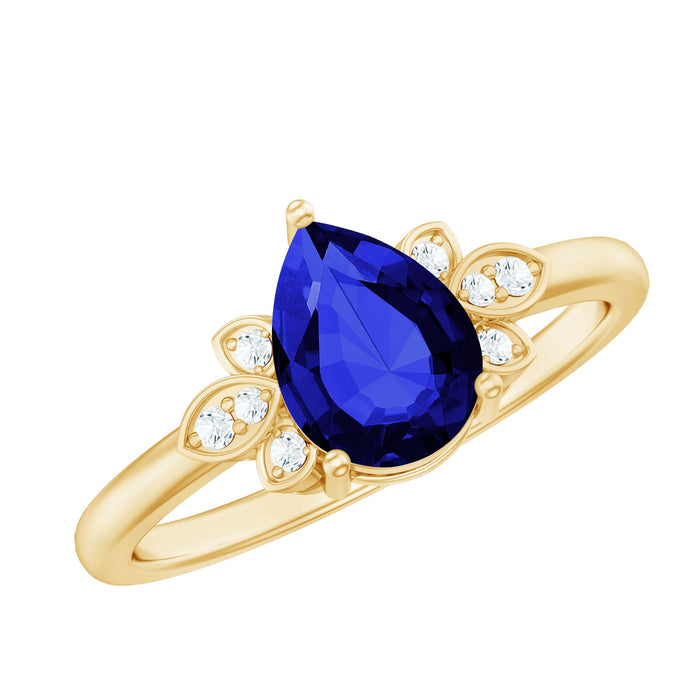 Lab grown blue sapphire teardrop engagement ring with diamonds from Rosec Jewels, showcasing a sparkling blue sapphire and diamond accents.