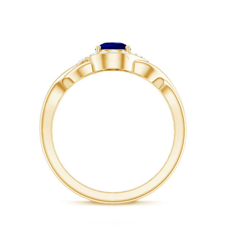 Lab grown blue sapphire and diamond teardrop engagement ring with crossover shank by Rosec Jewels, featuring a 1.6 carat gemstone.