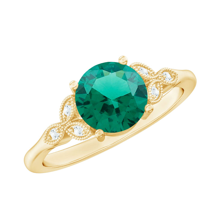 Lab-created emerald solitaire engagement ring with diamond accent, featuring a sleek band and vibrant green gemstone.