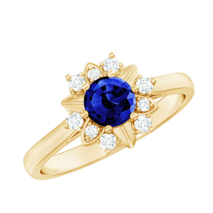 Lab grown blue sapphire flower engagement ring with diamonds, featuring a 0.6 carat center stone, from Rosec Jewels.