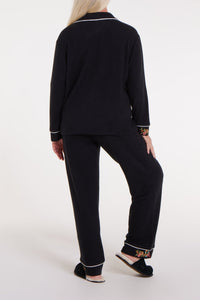 WeloWela Wela Pajama Adaptable Pant for women, back view showing comfortable fit and stylish design in black fabric.