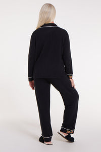 WeloWela Wela Pajama Magnetic Shirt for women in black, showing back view with magnetic closure and relaxed fit.