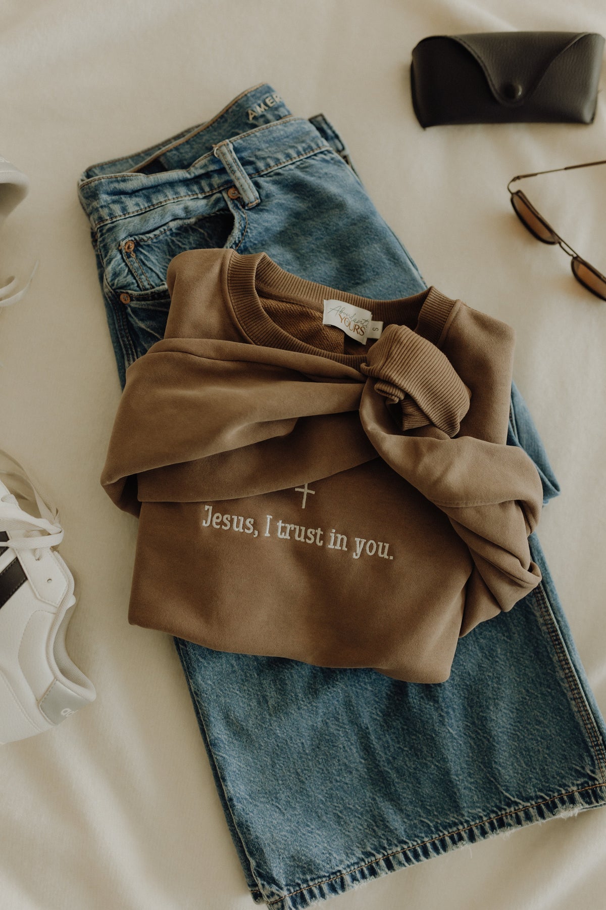 White cropped crewneck shirt featuring a religious Jesus image with the text "Jesus, I Trust in You" from Abundantly Yours Shop.