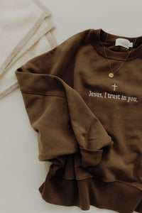 Cropped crew T-shirt featuring "Jesus, I Trust in You" text in white on a black fabric, from Abundantly Yours Shop.