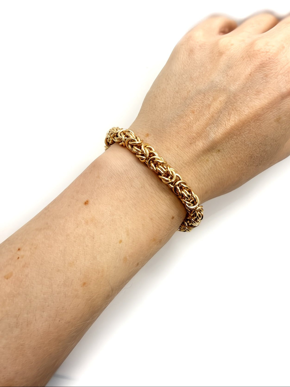 14K gold fill Byzantine chainmaille bracelet by Alison Morse worn on a model, showcasing its chunky, intricate design.