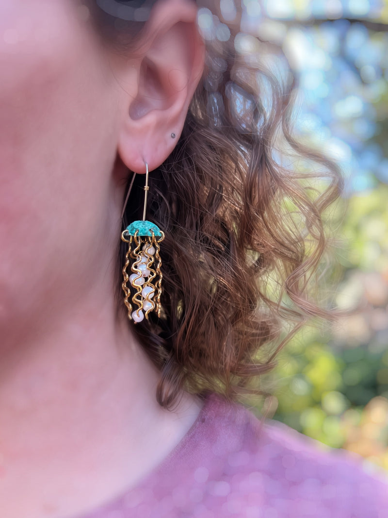 Green copper jellyfish earrings with white pearls and sterling silver earwires by Alison Morse. Close-up of the elegant jewelry.