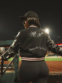Apple Bottom Jeans varsity jacket with a classic design, featuring a stylish vest style and bold branding.