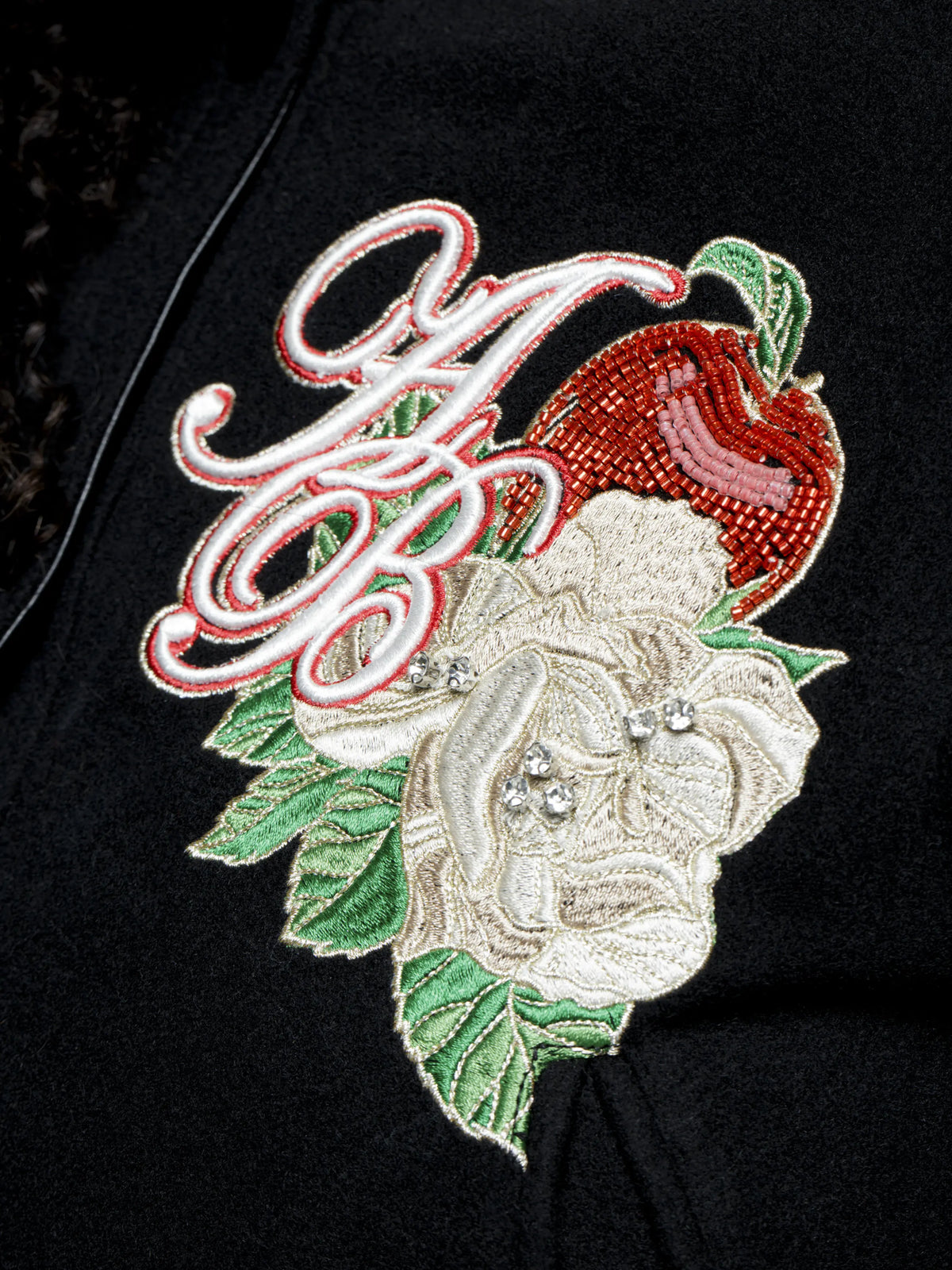 Apple Bottom Jeans varsity jacket with ribbed cuffs and collar, featuring a classic design in black with logo details.