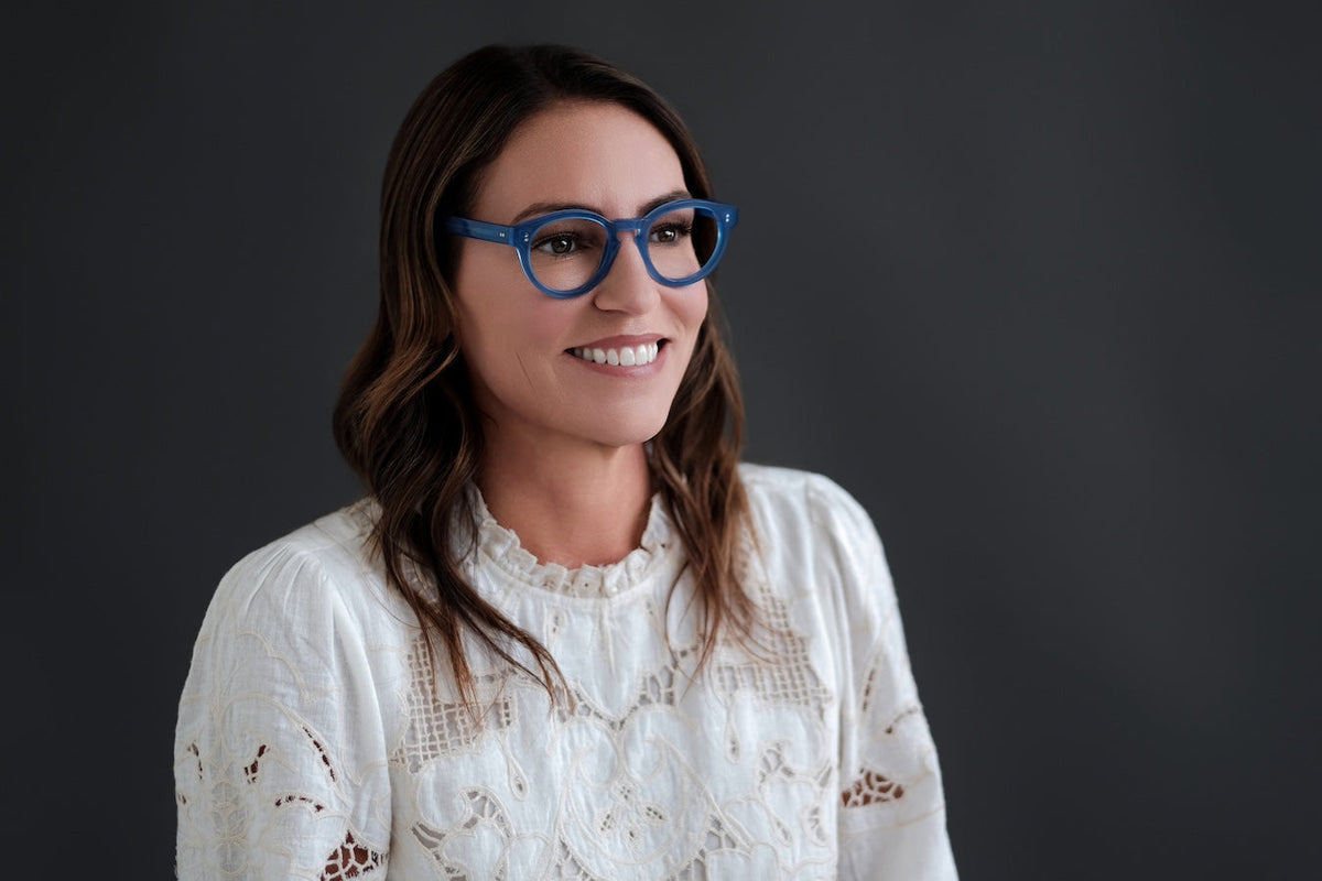 Blue translucent Benny's Eyewear Carter reading glasses with clear lenses and a sleek, modern design.