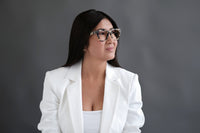 Eddie Benny's Eyewear reading glasses with clear lenses and black frames, placed on a white background.