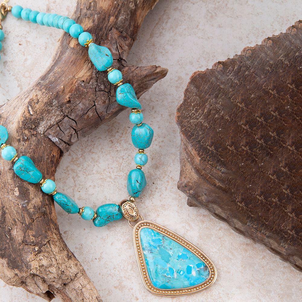 Blue turquoise triangle pendant necklace by Barse Jewelry featuring a golden chain and vibrant turquoise stone.