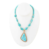 Blue turquoise triangle pendant necklace by Barse Jewelry featuring a gold chain and vibrant gemstone centerpiece.