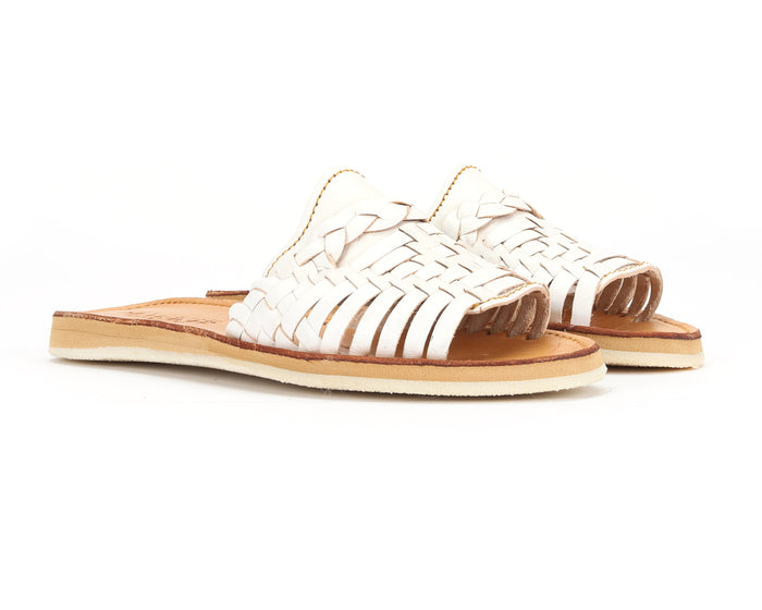 White Huarache Peep-Toe Slides by Bottomless Co. featuring open-toe design and woven strap details.