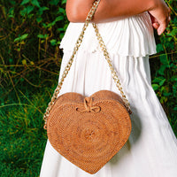 Natural brown BrunnaCo CINTA Atta rattan shoulder beach bag with gold chain strap and woven rattan design.