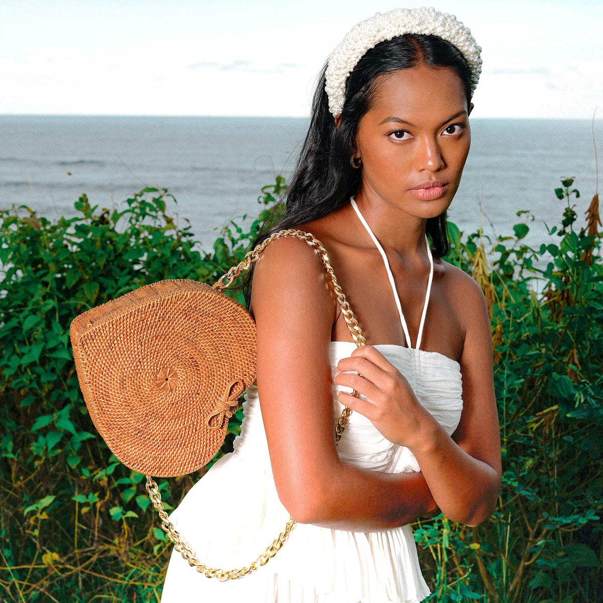BrunnaCo CINTA Atta Rattan Shoulder Beach Bag in natural brown with gold chain strap, stylish and spacious for beach outings.