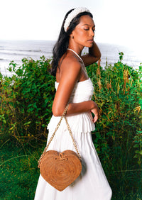 Natural brown CINTA Atta Rattan beach bag by BrunnaCo with gold shoulder chain strap, stylish and lightweight for summer outings.