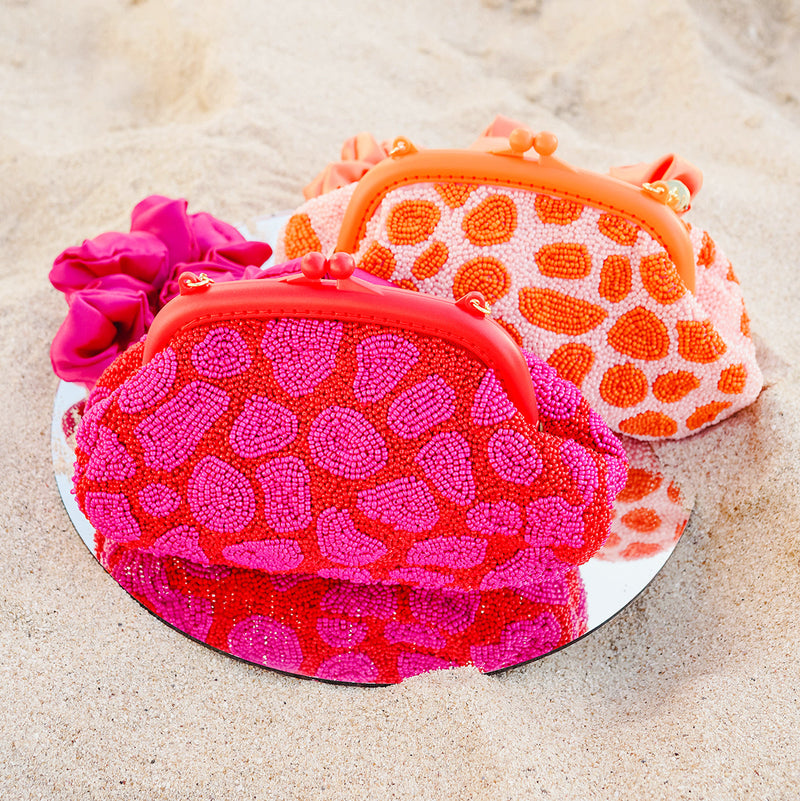 BrunnaCo The Arnoldi Jean hand-beaded clutch bag in red and pink with glass bead detailing, stylish evening accessory.