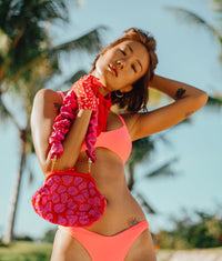 BrunnaCo The Arnoldi Jean hand-beaded clutch bag with pink and red glass beads, stylish and compact for evening occasions.
