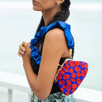 Beaded clutch bag by BrunnaCo featuring intricate embroidery and a compact design for elegant evening use.