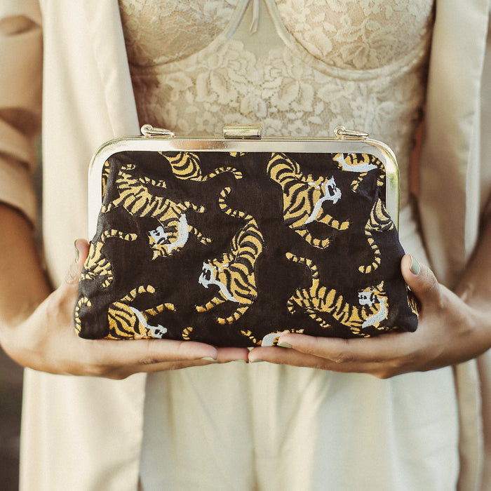 Black Sumatran Tiger Clutch Bag by BrunnaCo featuring textured faux leather and sleek design.
