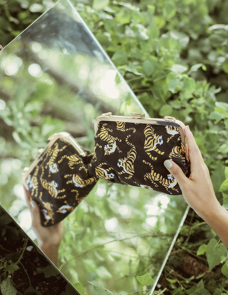 Black Sumatran Tiger Clutch Bag by BrunnaCo, featuring textured tiger pattern, elegant design, and compact size for evening use.