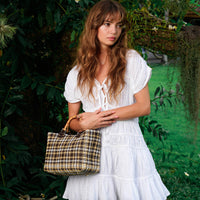 White The Srikandi Mini Ruffle Dress by BrunnaCo, featuring ruffled details and a stylish mini length, shown on a model.