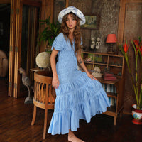 BrunnaCo Srikandi Ruffle Maxi Dress in Princess Blue, flowing fabric with ruffle details, full-length dress for elegant occasions.